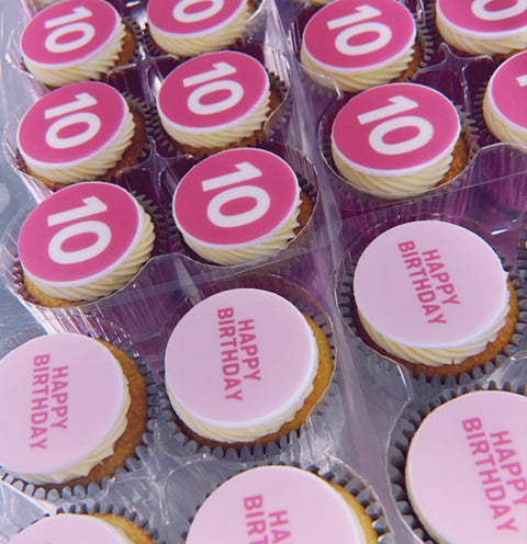 Pink happy birthday cupcakes, half with a number 10 and half with birthday message