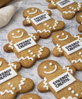 GINGERBREAD MEN WITH EDIBLE LOGO AND HAND PIPED ICING. DELIVERED ACROSS THE UK FROM PRINTCAKES.CO.UK