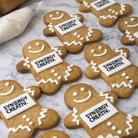 GINGERBREAD MEN WITH EDIBLE LOGO AND HAND PIPED ICING. DELIVERED ACROSS THE UK FROM PRINTCAKES.CO.UK