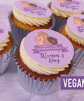 Vegan Cupcakes with Women's Day-themed toppers on a purple background