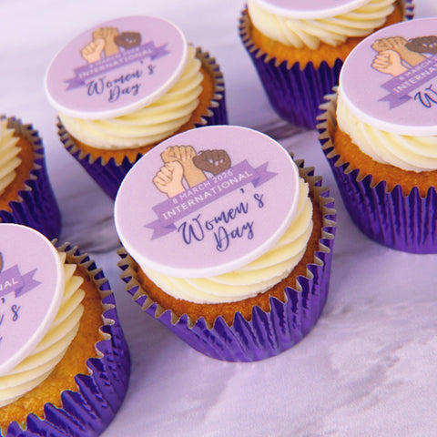 Cupcakes with International Women's Day-themed toppers in purple cases