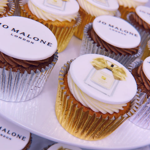 JO MALONE LONDON LOGO CUPCAKES - HALF WITH BRANDED AND HALF WITH PRODUCT IMAGE IN GOLD AND SILVER CASES