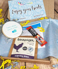 Tea and branded biscuit letterbox gift set with 'Printcakes' packaging on a wooden surface