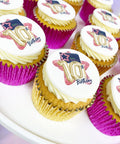 Cupcakes with '10th Birthday' branded toppers in pink and gold cases