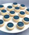 Customised macarons with printed logo on a white plate