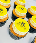 cupcakes for London delivery company with their logo in black cupcake cases