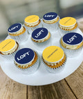 Dual branded cupcakes for company launch. Logos are edible printed toppers and cupcakes are vanilla buttercream