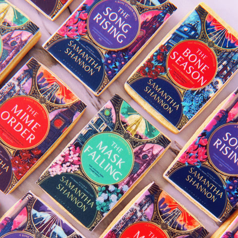 rectangle shaped biscuits for book launch with book cover graphic on icing topper for publishing house.