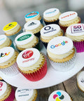 branded cupcakes with UK company logos printed onto edible icing discs. Showing brands like Virgin Money, Adidas, Land Rover and ITV. Available in gluten free and shown in a choice of case colours. 
