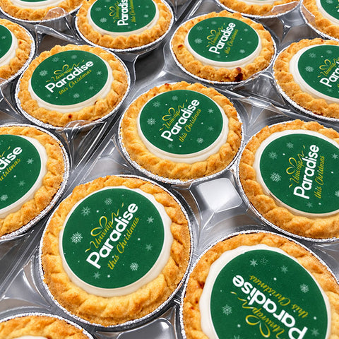 Close-up of mince pies topped with a custom Christmas design on edible icing