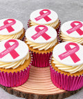 Vanilla cupcakes with buttercream and pink ribbon decorations for Breast Cancer Awareness Month