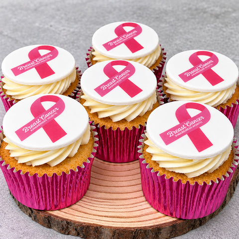 Vanilla cupcakes with buttercream and pink ribbon decorations for Breast Cancer Awareness Month
