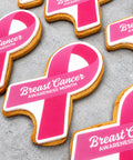 Pink and white breast cancer awareness month ribbon shaped biscuits