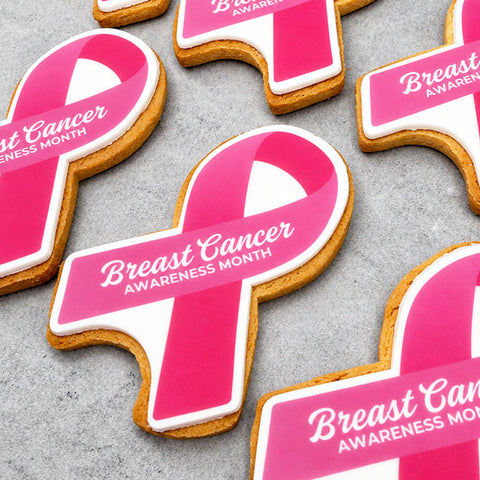 Pink and white breast cancer awareness month ribbon shaped biscuits