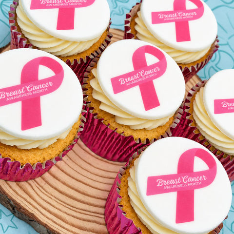 Close-up of pink ribbon cupcakes for Breast Cancer Awareness Month office events