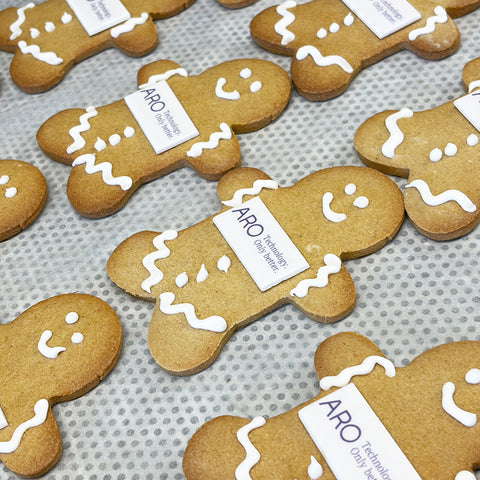 gingerbread men biscuits with company logo on a baking tray ready for delivery