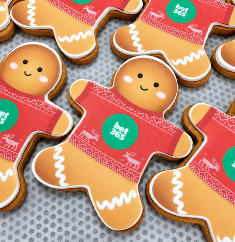gingerbread men with christmas jumpers on and company logo for gift. 