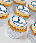 International Men's Day cupcakes with blue tie toppers and vanilla buttercream in silver foil cases