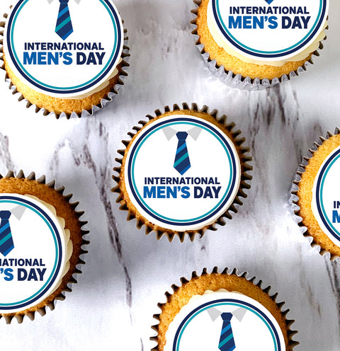Overhead view of International Men's Day cupcakes with blue tie design toppers on marble table for office event
