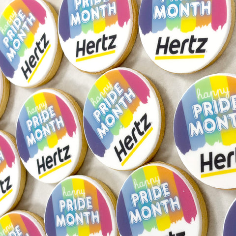 pride month design branded biscuits with company logo and rainbow icing