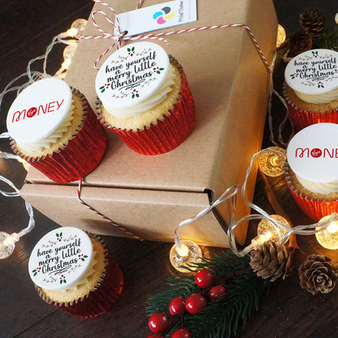 Dual branded cupcakes - half with a Christmas message and half with a company logo in a festive setting. 