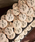 personalised macarons for a wedding with the couples initials dark green and foliage print. 