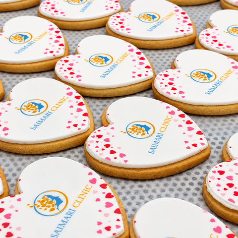 valentines day biscuits with heart iced decorations and a company logo for event
