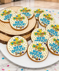 Round iced biscuits decorated with a "Welcome to your new office" design, served on a plate for a new office celebration