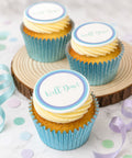 Cupcakes with white frosting, each topped with a round white edible icing disc that reads "Well Done!" Ready for uk delivery